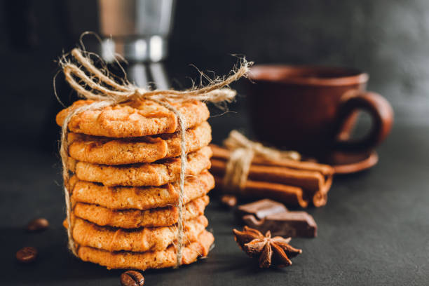 istock Homemade chip cookies stacked on dark background 1191849325