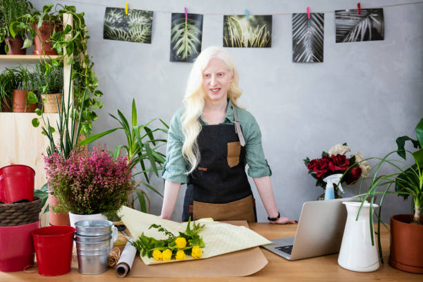 istock Young albino woman florist 1191849734