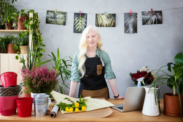 istock Young albino woman florist 1191850668
