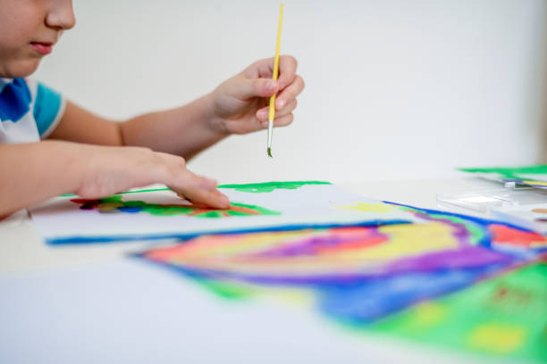 istock Boy painting with watercolors 1191851244