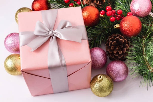istock Beautiful pink gift box with Christmas ornaments 1191852116