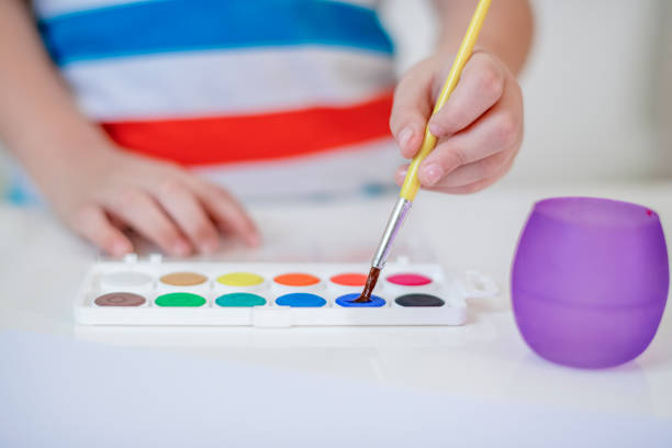 istock Boy painting with watercolors 1191852789