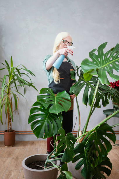 istock Young albino woman florist 1191853588
