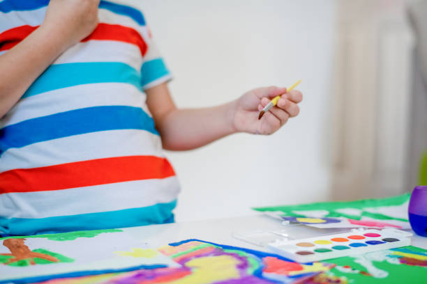 istock Boy painting with watercolors 1191853650