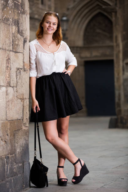 istock smiling female standing near the stone wall 1191854659