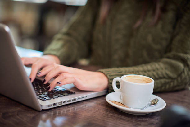 istock Woman typing on laptop in cafe. 1191855161