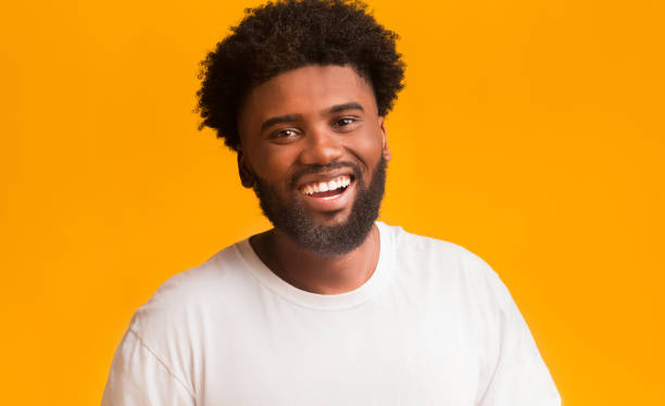 istock Cheerful black man laughing over orange background 1191856156