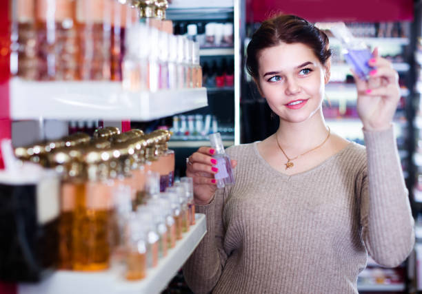 istock Young girl customer is searching for strong perfume 1191856273