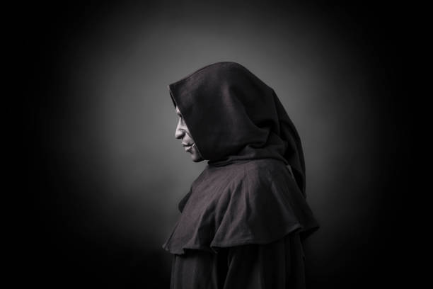 istock Scary figure in hooded cloak with mask 1191856501