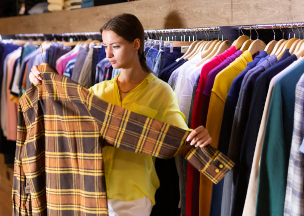 istock Woman choosing male clothes 1191858661