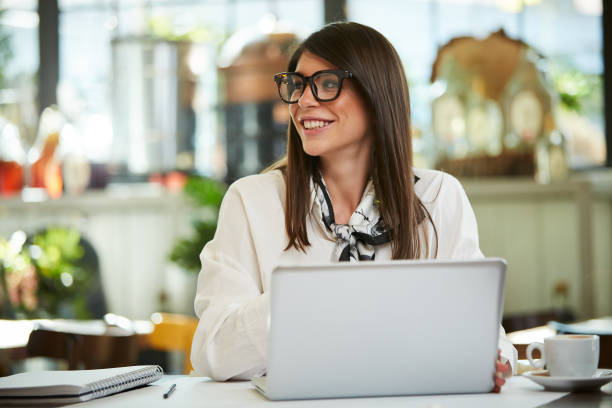 istock Businesswoman using laptop in cafe. 1191859194