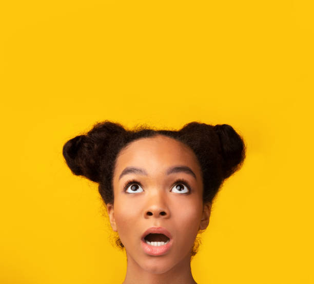 istock Surprised african teen looking upwards at empty space 1191860026
