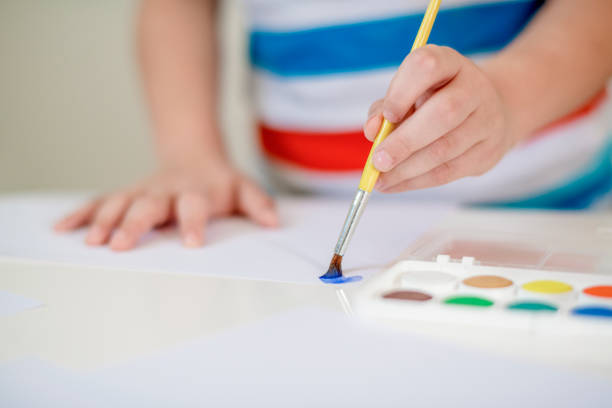 istock Boy painting with watercolors 1191860571