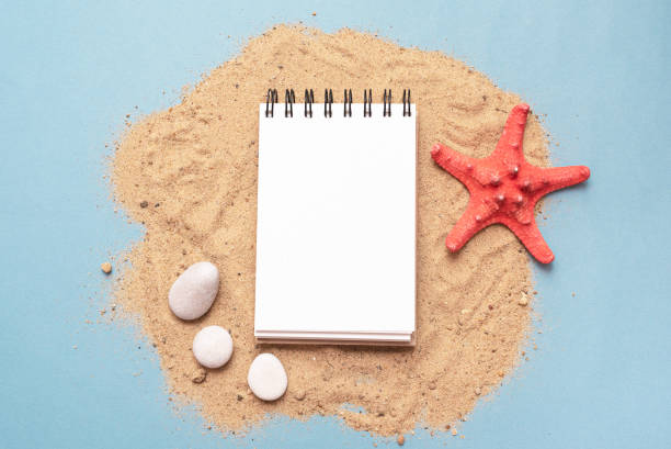 Travel concept. Notepad on the sand flat lay background. Sea vacation diary mockup. Summer to do list template. shell starfish orange sea stock pictures, royalty-free photos & images