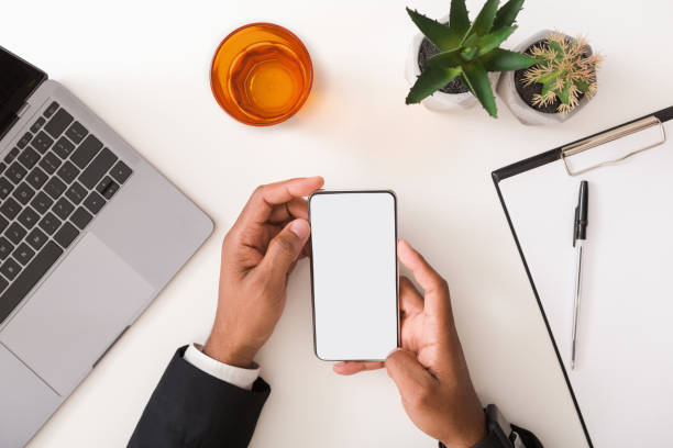 istock Man in suit using blank smartphone on workplace desk 1191862496