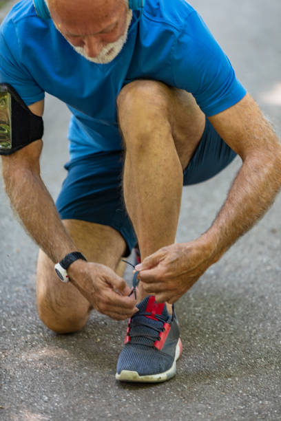 istock Senior Athlete Tying Sneaker Shoe 1191862684