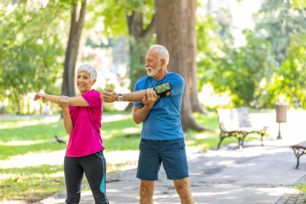 istock Mature Couple is Doing Warm-up Exercise in Public Park 1191863203