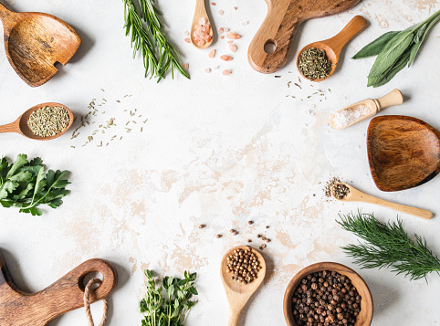 Fresh raw Herbs, various spices and wood kitchen were frame on textured background. top view, copy space.