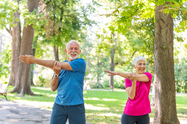 istock Active Senior Couple is Stretching Outdoors in Nature 1191864345