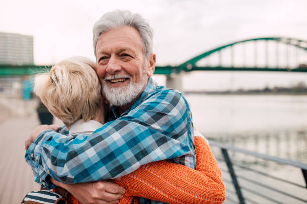 istock Senior couple embracing by the river 1191865370