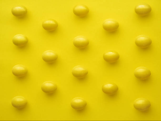 Pattern Of Chicken Eggs Arranged In Line Against Yellow Background.