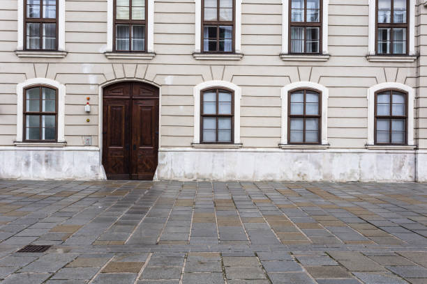 istock Several windows along with vintage wooden doors on display outside classic european building 1191865502