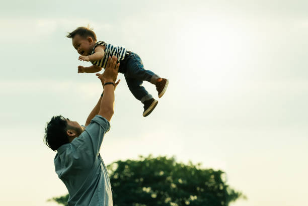 istock Side View Of Man Playing With Son Against Sky 1191867505