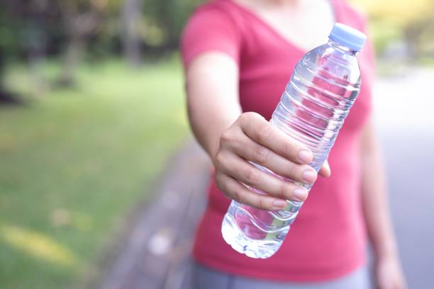 istock Woman is drinking clean water to refresh the body. 1191868779