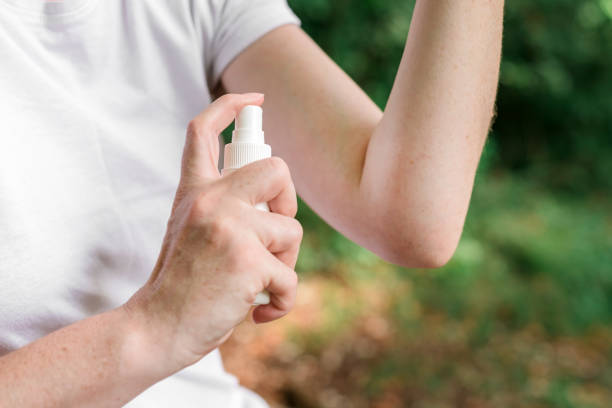 istock Female hiker using antiseptic spray outdoors during hiking 1191869064