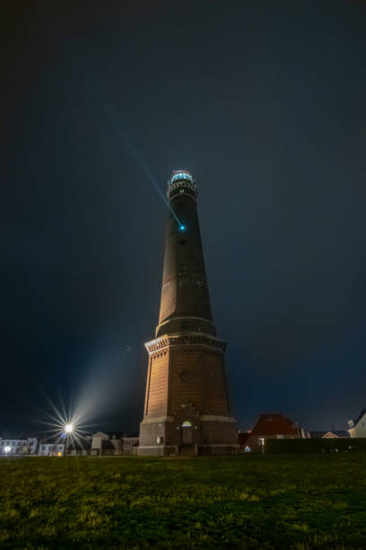istock lighthouse at night on island Borkum, travel germany 1191869075