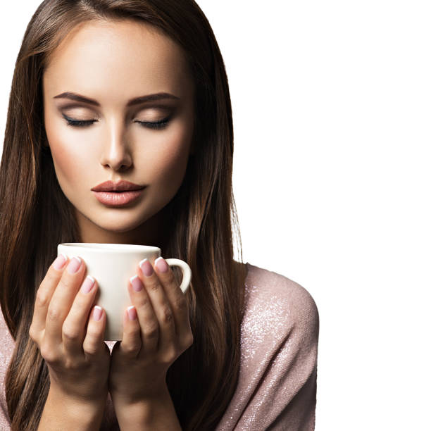 Woman with cup of coffee. Beautiful adult girl hods in hands mug with hot drink - on white background