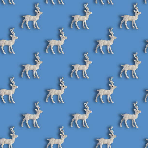 istock Seamless Christmas pattern with Xmas white deer on blue background. 1191870676