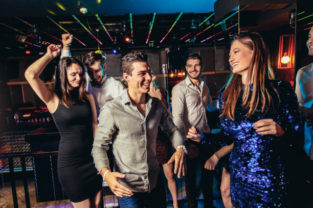 istock Friends dancing in night club and having fun 1191870910