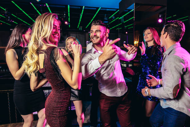 istock Friends dancing in night club and having fun 1191872937