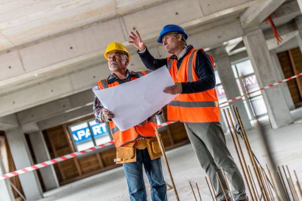 istock Foreman discussing blueprint with coworker 1191873301