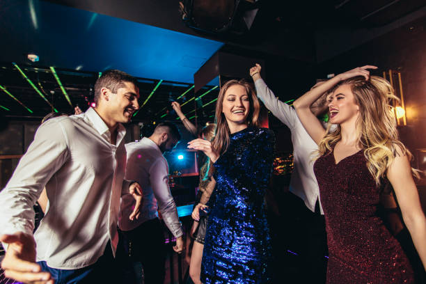 istock Friends dancing in night club and having fun 1191875892
