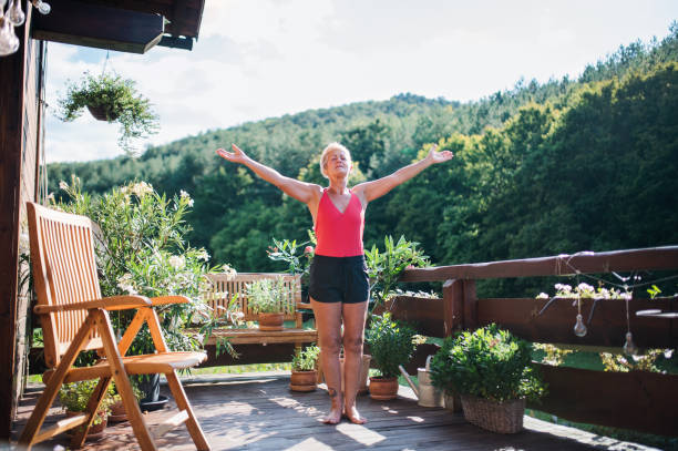 istock A senior woman standing outdoors on a terrace in summer, doing exercise. 1191875941