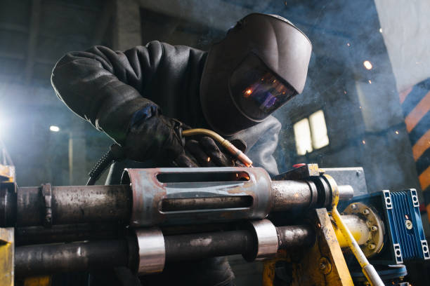 istock Craftsman examining metal piece between flashes It's fixed with industrial clamp 1191877182