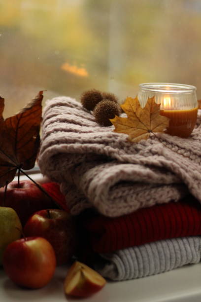 istock Autumn layout of woolen things, a lighted candle and apples 1191877216