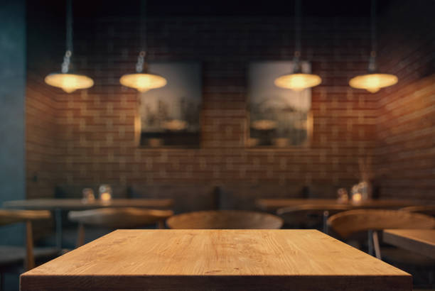 Empty tabletop in the coffe shop Empty tabletop in the coffe shop at night over defocused background with copy space cafe stock pictures, royalty-free photos & images