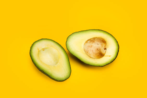 istock Cuted avocado on a yellow background 1191882067