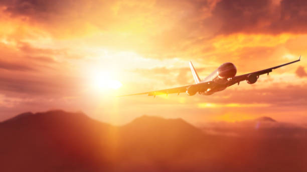 istock Airplane flying over mountain on dramatic sunset sky abstract background. 1191884183