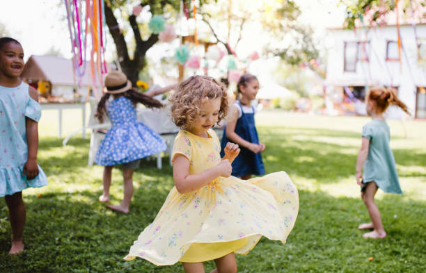 istock Small children standing outdoors in garden in summer, playing. 1191884190