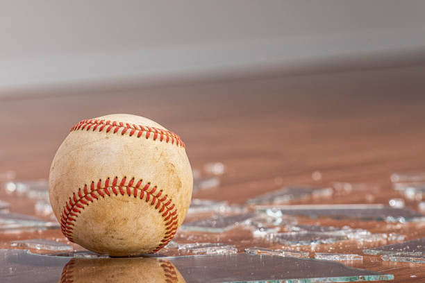 istock A baseball with broken glass from a window on the floor 1191888719