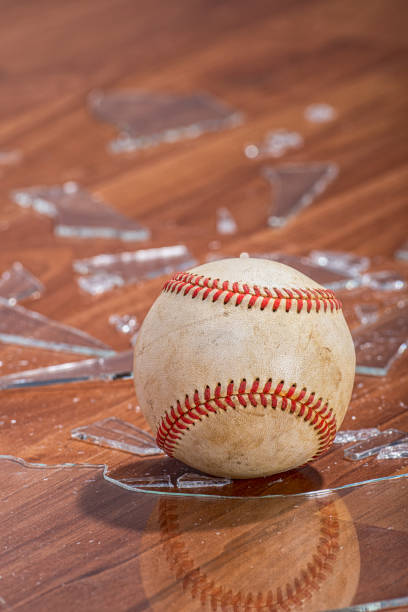 istock A baseball with broken glass from a window on the floor 1191889363