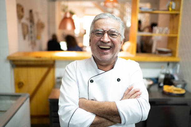 istock Portrait of smiling senior chef in a kitchen 1191889440