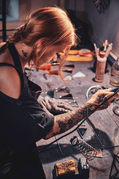 istock Diligent woman is working on her own project at glass workshop. 1191890033