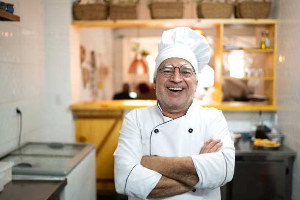 istock Portrait of smiling senior chef in a kitchen 1191890073