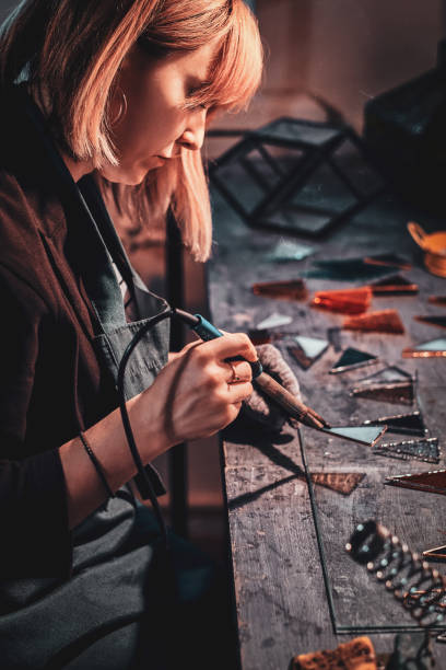 istock Woman is working on her lamp project at lamp studio. 1191892838