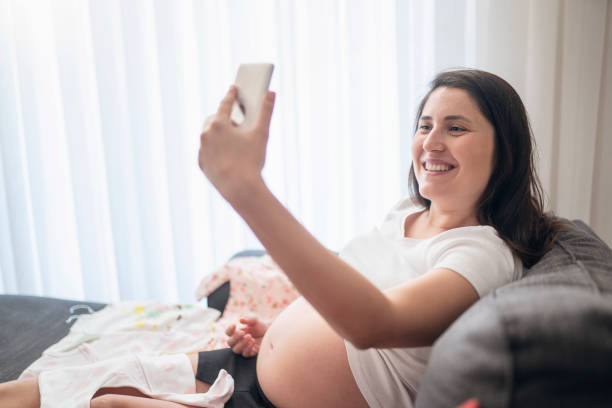 istock Baby clothes, taking photo 1191892904